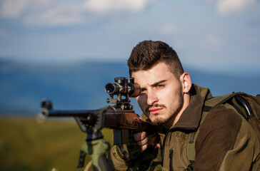 Hunter is aiming. Shooter sighting in the target. The man is on the hunt. Hunt hunting rifle....