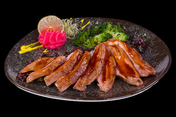 Delicious turkey fillets teriyaki in a plate, with reflection,
