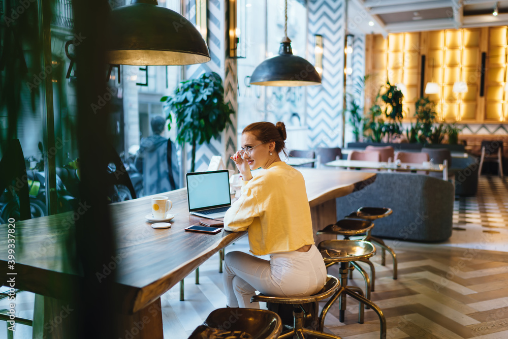 Poster puzzled female manager of loft cafeteria solving problem during smartphone communication with provid