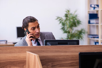Young male employee working in the office