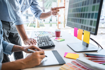 Young colleagues designers working together on a creative project and color samples for selection, Color swatch samples, Brainstorming Planning Partnership, creative graphic design working desktop