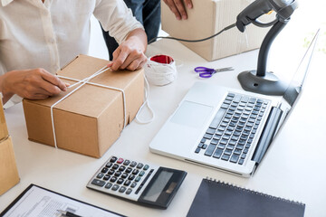 Small business owner delivery service and working packing box, business owner working checking order to confirm before sending customer in post office, Shipment Online Sales