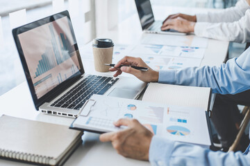 Teamwork of business colleagues consultation market growth on financial document graph report...