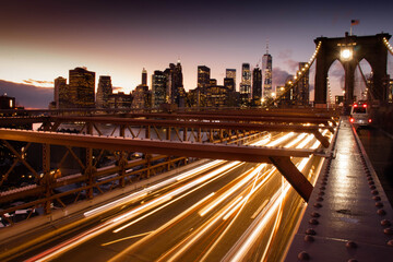 Fototapeta premium Brooklyn Bridge in New York City Long exposure with skyline in background at dusk
