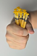 Vaccine application syringes clenched into fists