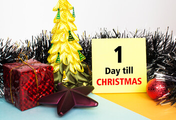 Christmas tree decorated with toys and tinsel, gift boxes and Yellow sticker with text 1 days till...
