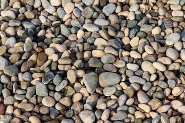 Smooth round pebbles texture background. Pebble sea beach close-up