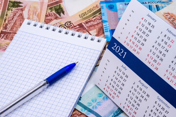 Calendar and money. Ruble bills and stationery.