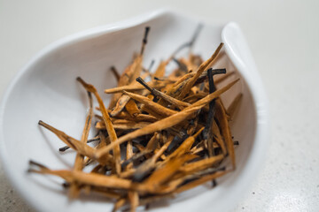 Dian Hong Jin Si. Golden needle (red tea from Yunnan). Beautiful and delicious oxidized tea golden tips leaves in a porcelain container. 