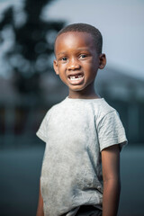 portrait of african boy, black kid with a shown teeth-outdoor concept