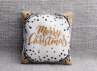 Holiday pillow with Merry christmas text