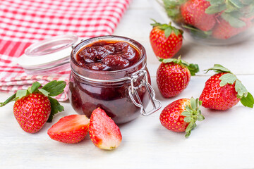 Bowl of strawberry jam isolated on white background from top view