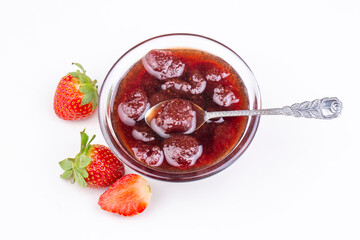 Bowl of strawberry jam isolated on white background from top view