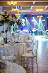 A beautiful vase of flowers on a table in a luxury restaurant. Wedding decorations