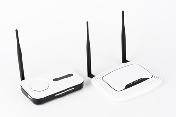 Two wifi routers, wireless devices with one and two antennas on white background.