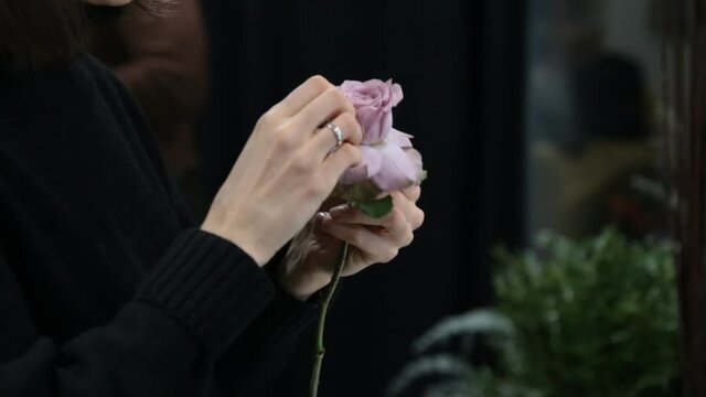 girl florist prepares flowers for making a bouquet of flowers
