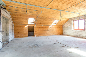 empty interior in house without repair on wooden mansard  floor and brick wall