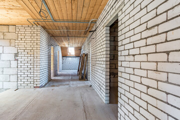 empty interior in house without repair on wooden mansard  floor and brick wall