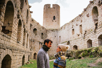 Couple stare at each other inside an abandoned castle. Adventure concept