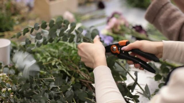 girl florist prepares flowers for making a bouquet of flowers