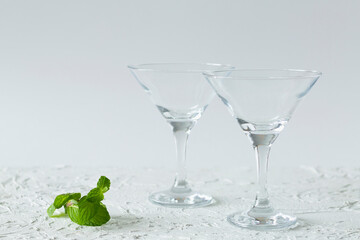 two empty martini glasses of cocktail on white background. alcohol drinks. Glasses for cocktail on the table. copy space
