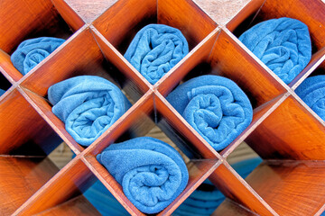 Fototapeta na wymiar Rolled beach towels on a shelf