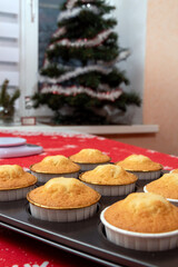 Fresh cupcakes in the form of a blurred background of the Christmas tree. Selective focus.