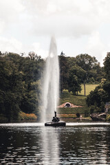 A snake-shaped fountain in the middle of a lake