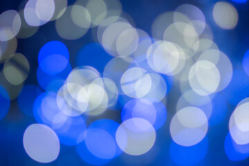 Blue bokeh, blurred background, christmas background. Neon color.