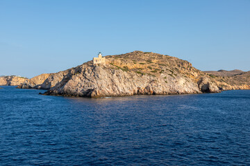 Fototapeta na wymiar View of the lighthouse on the peninsula, Chora , Ios Island, Greece.