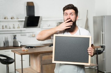 shopping sale and discounts. chef menu in kitchen. look over there. chalkboard for advertising. oh my god. brutal hipster man holding blank board, copy space. job search. there are vacancies - Powered by Adobe