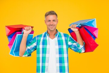 cheerful man shopaholic buy many gift packs in mall, black friday