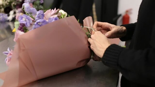 girl florist prepares flowers for making a bouquet of flowers