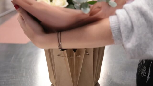 girl florist prepares flowers for making a bouquet of flowers