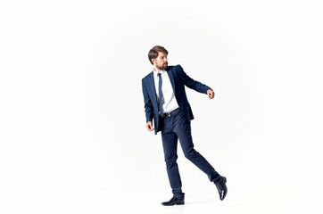 Fototapeta na wymiar business man in a suit and shoes walks to the side on a light background Copy Space