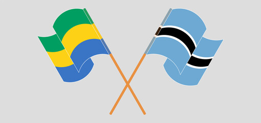 Crossed and waving flags of Gabon and Botswana