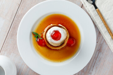 Egg flan with cream, cherries and mint