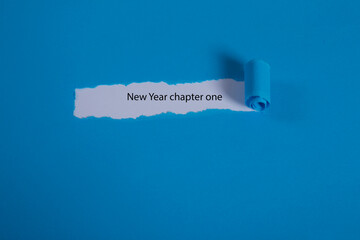The text new year appearing behind torn blue paper.
