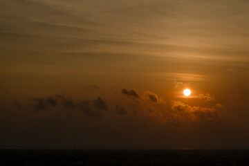 Beautiful sunset red sun over city.