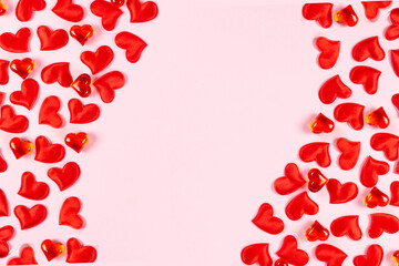Valentine's Day, wedding, love concept. Celebration pink background with red satin hearts. Top view, flat lay, copy space.
