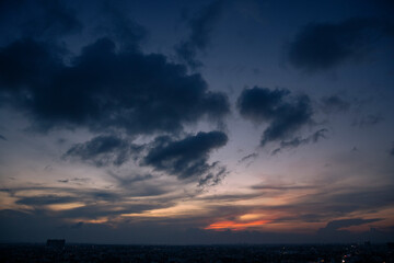 Beautiful sunset clouds over city.
