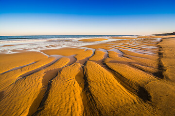 Orange sand beach in sunrise on the shore of North Atlantic Ocean in Mimizan Plage
