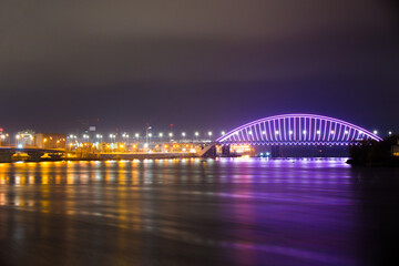 View of the Podilskyi Bridge with bright lights at night
