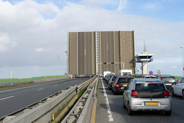 Open bridge with cued cars waiting at Ketelbridge Lelystand The Netherlands