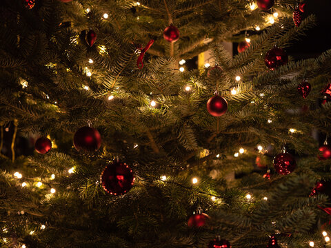 Christmas tree with red balls, decoration and lightning.