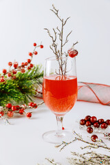 Cranberry beverage with fresh berries on white background.