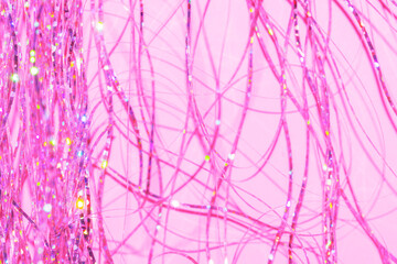 festive holographic tinsel fringe detail on pink background