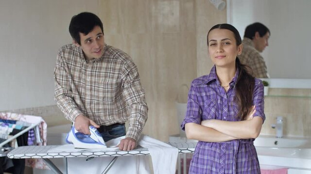 Husband henpecked ironing his shirt