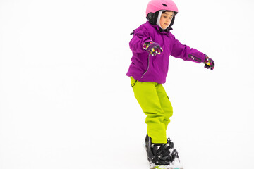 Snowboard Winter Sport. little girl learning to snowboard, wearing warm winter clothes. Winter background.