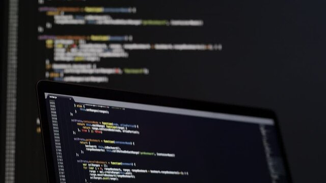 Real Javascript code. Front end web development. Java script JS code on laptop screen. Web design concept.